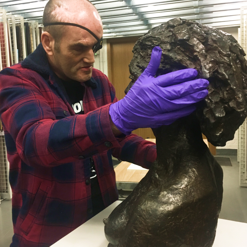 A blind visitor at The Whitworth gets hands on with a sculpture by Jacob Epstein
